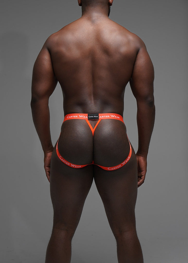 Man wearing bright orange underwear with a gray background